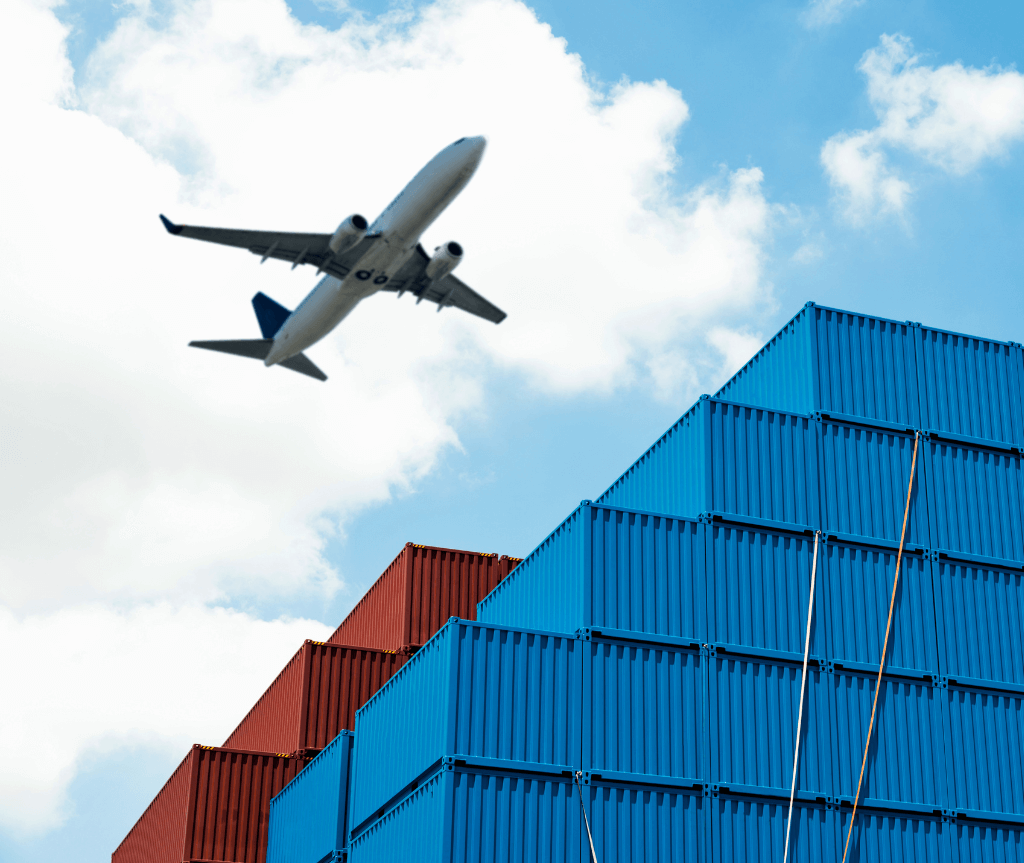 Plane flying over containers